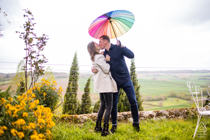 The couple can be seen embracing in a romantic embrace under an umbrella in the quaint countryside of Castelnau, Lectoure, Gers, France