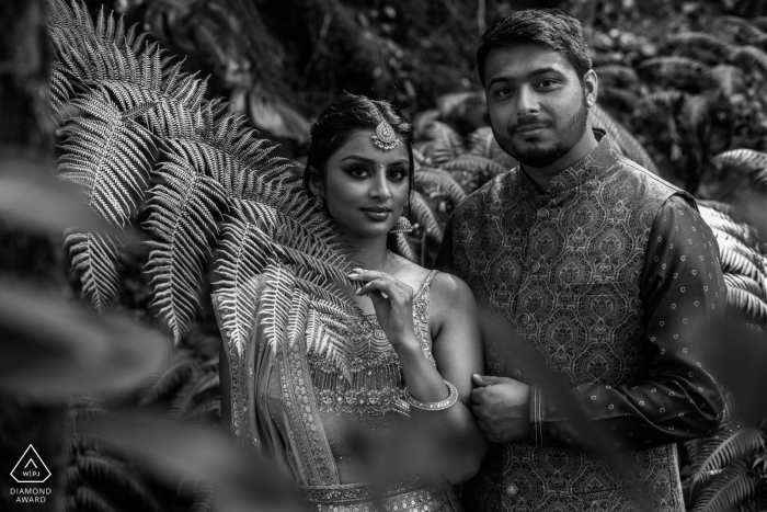 An engagement portrait was taken in Sintra, Lisbon featuring a couple, captured in black and white against a backdrop of nature.