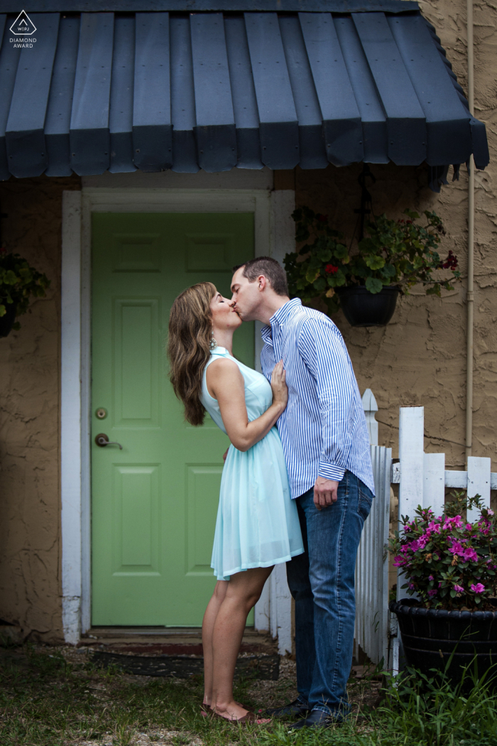 In front of a Roswell antique store, the couple shares a kiss under a blue awning, encapsulating romance in vintage style. - Vintage Romance: Awning Kiss Capture