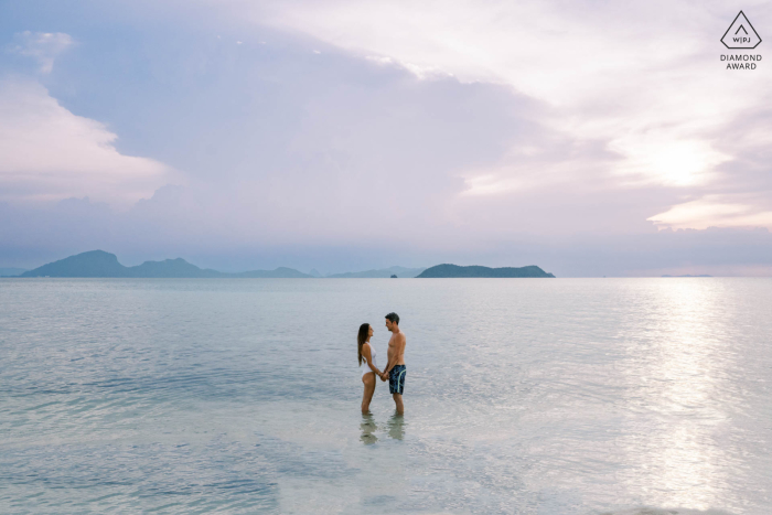 Pre-Wedding Romance on Rap Island in Thailand's Ang Tong Marine Park This pre-wedding portrait was taken at Rap Island in Ang Tong Marine Park, Thailand. The stunning couple poses together on the shoreline the day before their wedding.