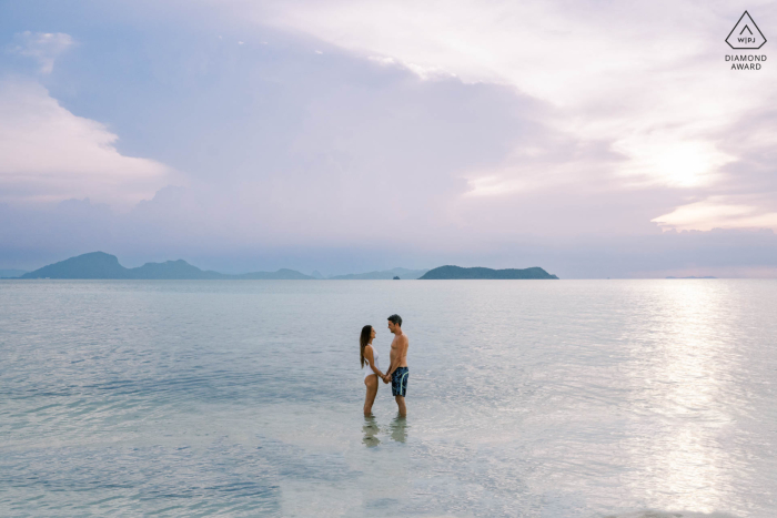 This pre-wedding portrait was taken at Rap Island in Ang Tong Marine Park, Thailand. The stunning couple poses together on the shoreline the day before their wedding.