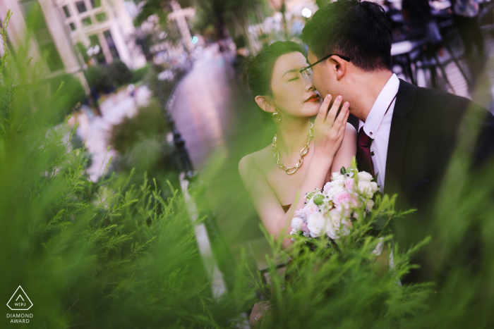 Engagement Portrait by Professional Wedding Photographer: The Perfect Garden Twilight Shot by a Photographer in Shanghai A unique image captured by a WPJA photographer at the Bund in Shanghai, China, showcasing the engaged couple's gentle embrace during a romantic garden portrait session at twilight.