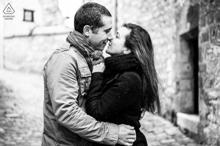 Captured in the charming streets of Châteauroux, the future bride and groom are caught in a tender embrace just before sharing a kiss. The anticipation and affection between them create a romantic and timeless scene.