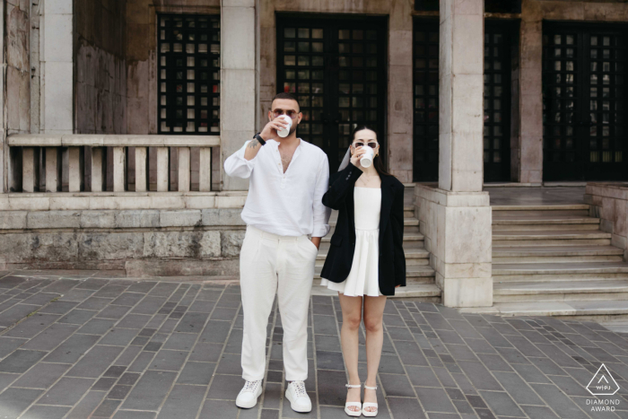 Beyoglu Bliss: Sipping Coffee and Love in Istanbul's Charming Streets A happy couple enjoying coffee together in front of a picturesque Old World building, captured by a wedding photographer in the charming neighborhood of Beyoglu, Istanbul.