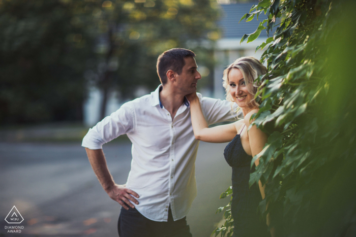 In Vácrátót, Hungary, a couple shares a tender photo session surrounded by lush greenery, capturing the essence of being with their beloved in a serene, natural setting.