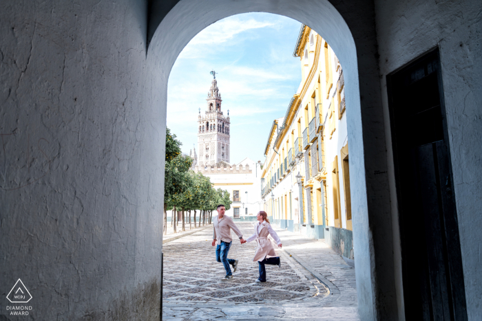 Pre-Wedding Moment Amidst Sevilla's Historic Charm and Lively Cultural Ambiance A couple cherishes a sweet pre-wedding moment in Sevilla, AndalucĂa, Spain, enveloped by the city's rich history, picturesque architecture, and lively cultural ambiance.