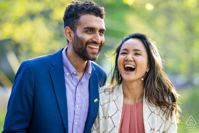 A joyful couple shares a laugh at Pine Lake, Georgia, in a sweet engagement portrait.