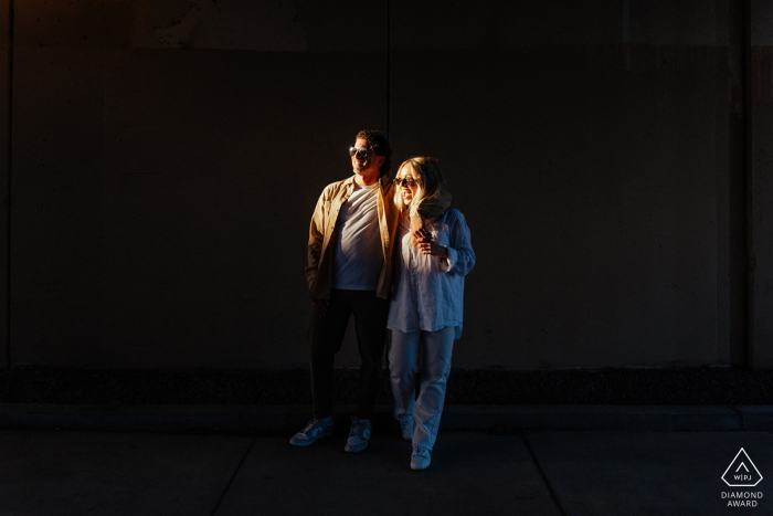 Engaged couple walking together at sunset on a charming Old City, Philadelphia street.