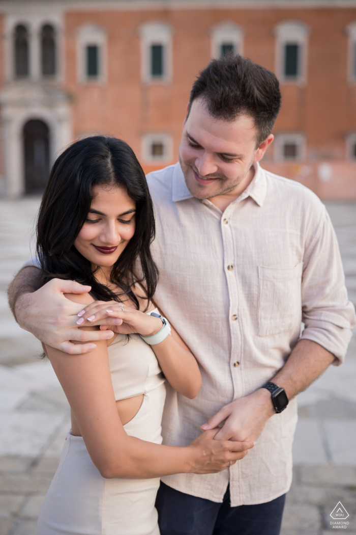 San Giorgio Island, Venice. A newly engaged couple poses, showing off the ring.