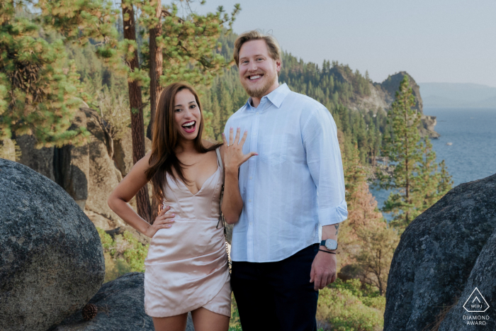 Lakeside Joy and Engagement Ring Reveal at South Lake Tahoe Couple Portrait Session At South Lake Tahoe, CA, the couple poses against a stunning lakeside backdrop, as she proudly displays her engagement ring, capturing their excitement and joy.
