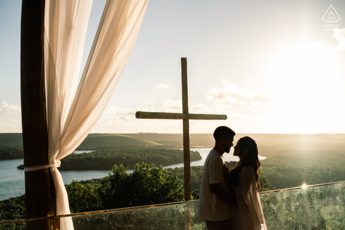 A striking silhouette of the engaged couple is captured against the vibrant glow of the sunset at Mar de Eucaliptos, highlighting their romantic connection within the beautiful Brazilian landscape.
