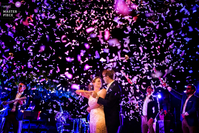 Photo by: <a href="https://www.wpja.com/contests/2018-v01-photography-competition/best-wedding-photographers/2165786">Fabio Mirulla - Montevarchi Arezzo</a> Arezzo wedding photographer captured this image of the bride and groom dancing under a shower of purple confetti under a night sky