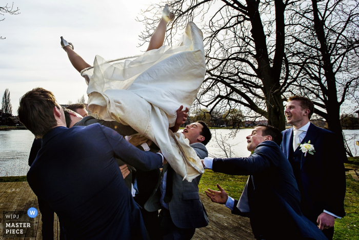 Photo by: <a href="https://www.wpja.com/contests/2018-v01-photography-competition/best-wedding-photographers/2166061">Damon Pijlman - Wassenaar Zuid Holland</a> Netherlands wedding photographer created this silly image of a bride being tossed in the air by the groomsmen