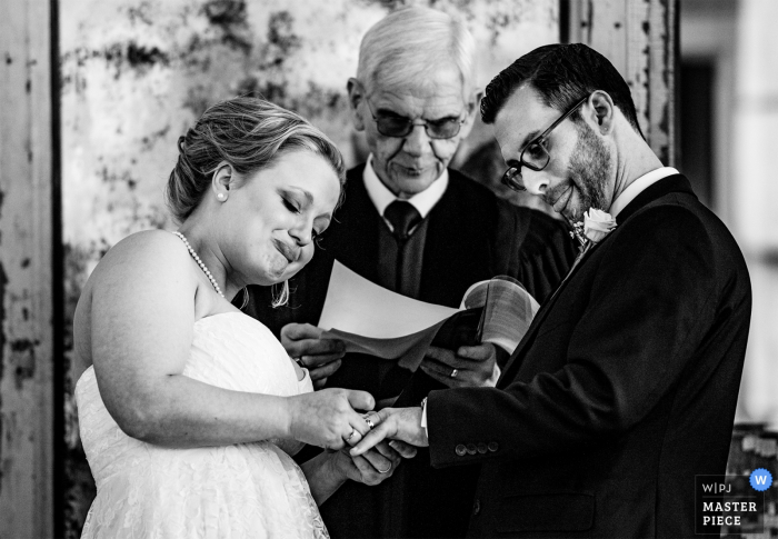 Photo by: <a href="https://www.wpja.com/contests/2018-v01-photography-competition/best-wedding-photographers/2166376">James Nix - Charlotte North Carolina</a> Bride putting the ring on the grooms finger Parlour at Manns Chapel