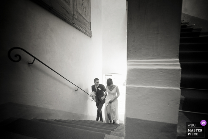 Photo by: <a href="https://www.wpja.com/contests/2018-v01-photography-competition/best-wedding-photographers/2166726">Alessandra Diamanti - Cremona</a> Ripalta Guerina, Italy bride and groom walk up the stairs