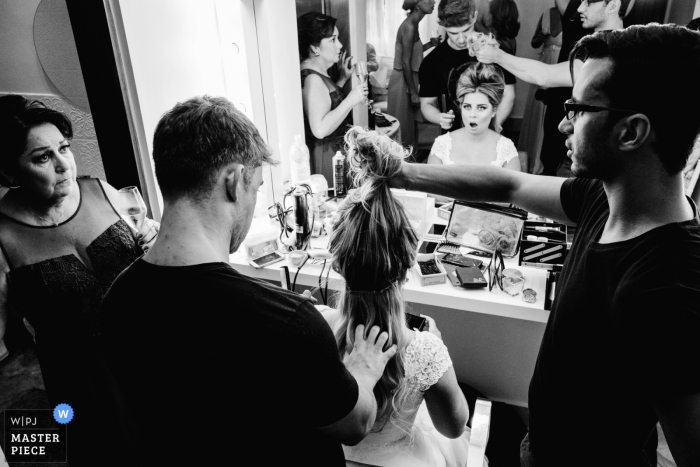 Sao Paulo, Brazil bride getting help with her hair and make up before the wedding