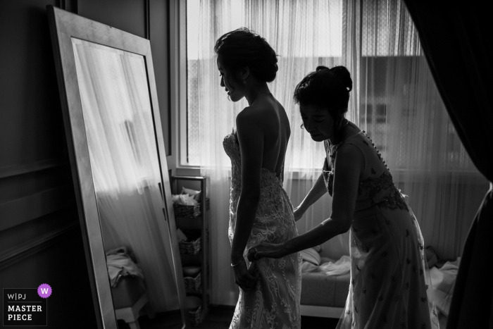 Photo by: <a href="https://www.wpja.com/contests/2018-v01-photography-competition/best-wedding-photographers/2169551">Chris Shum - Sunnyvale California</a> Bride getting dressed at Daly City studio - California Wedding Photo