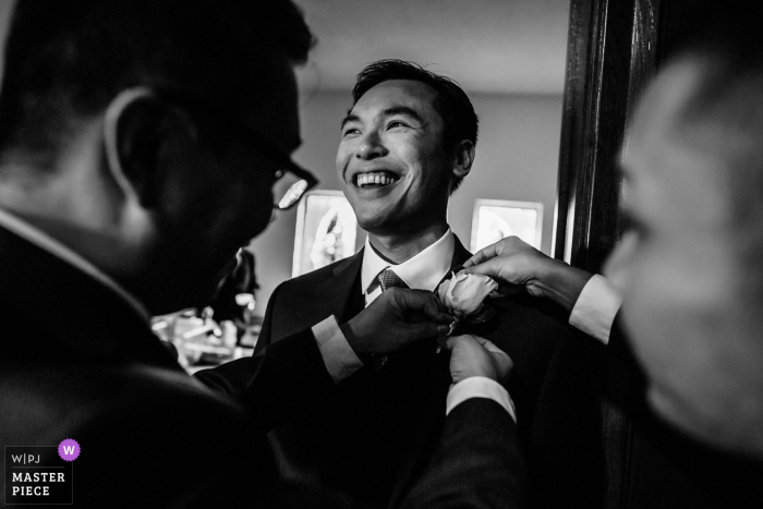 Photo by: <a href="https://www.wpja.com/contests/2018-v01-photography-competition/best-wedding-photographers/2169581">Chris Shum - Sunnyvale California</a> Groom getting ready with help at the St Robert's Catholic Church in San Bruno
