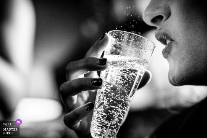 Photo by: <a href="https://www.wpja.com/contests/2018-v01-photography-competition/best-wedding-photographers/2170246">Paul Rogers - Hitchin Hertfordshire</a> Lodon woman enjoying a drink from a glass at the wedding