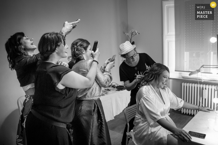 Photo by: <a href="https://www.wpja.com/contests/2018-v01-photography-competition/best-wedding-photographers/2171446">Samuele Ciaffoni - Ancona Ancona</a> Marche bridesmaids taking photos of the bride as she gets her hair ready before the wedding