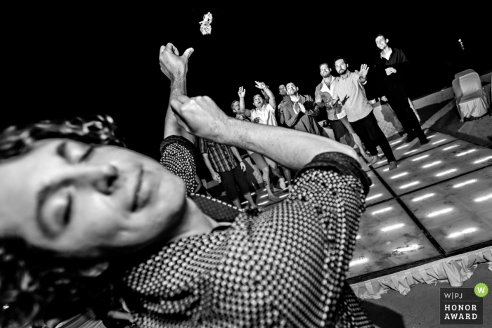 Puerto Vallarta, Mexico wedding reception photographer - the garter is shot to the single men on the dance floor