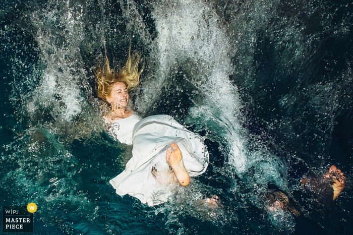 Photo by: <a href="https://www.wpja.com/contests/2018-v01-photography-competition/best-wedding-photographers/2172881">Maria Shalaeva - Moscow </a> Moscow bride jumps into the water while in her dress