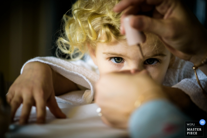 Photo by: <a href="https://www.wpja.com/contests/2018-v01-photography-competition/best-wedding-photographers/2173071">Jason Brown - Chicago Illinois</a> Thompson Chicago little child watches in amusement as her finger nails are painted