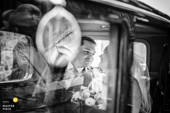 Photo by: <a href="https://www.wpja.com/contests/2018-v01-photography-competition/best-wedding-photographers/2173756">Nick Despres - Guernsey Guernsey</a> Guernsey bride and groom smile at each other while in the car after the wedding
