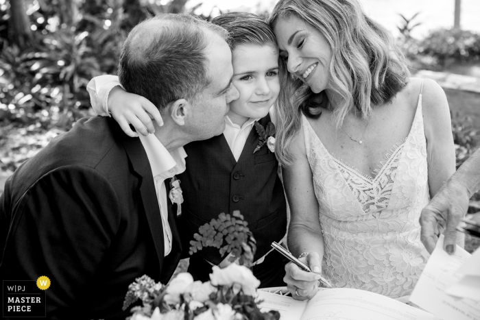 Photo by: <a href="https://www.wpja.com/contests/2018-v01-photography-competition/best-wedding-photographers/2174061">Florent Vidal - Sydney New South Wales</a> Sydney, Australia Wedding Photo of Certificate signing with Bride, Groom and young boy.