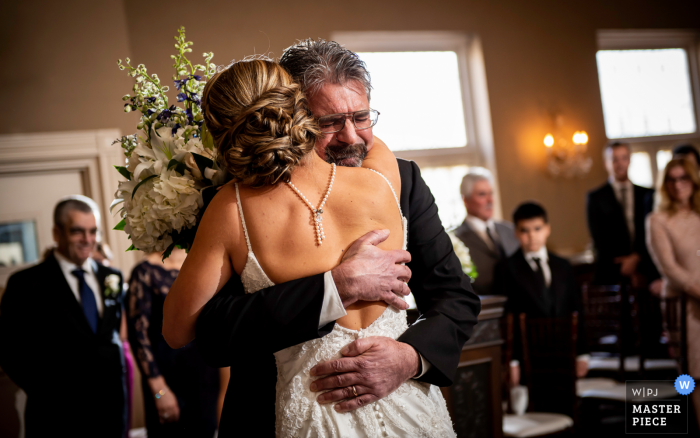 Photo by: <a href="https://www.wpja.com/contests/2018-v01-photography-competition/best-wedding-photographers/2174486">Janine Collette - Washington New Jersey</a> New Jersey Davids Country Inn Wedding Photo of Dad Hugging Bride During the Ceremony