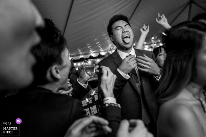 Photo by: <a href="https://www.wpja.com/contests/2018-v01-photography-competition/best-wedding-photographers/2174621">Annie Bang - Los Angeles California</a> Oak Glen, California groom having fun with the guests at the reception