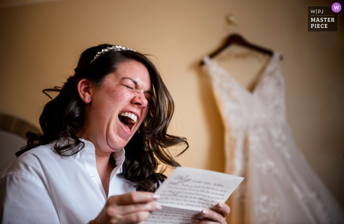 Photo by: <a href="https://www.wpja.com/contests/2018-v01-photography-competition/best-wedding-photographers/2174641">Janine Collette - Washington New Jersey</a> New Jersey bride reading a letter from her fiancé before the wedding with her dress in the background