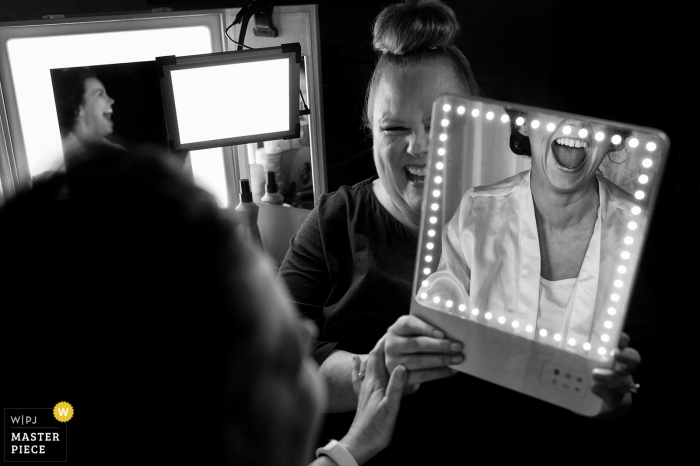 Photo by: <a href="https://www.wpja.com/contests/2018-v01-photography-competition/best-wedding-photographers/2174716">Tara Theilen - Carson City Nevada</a> Yosemite, California bride smiles as she sees her make up in the mirror