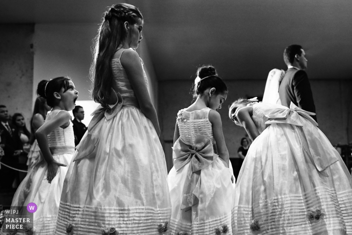 the young girls talking and yawning during the wedding ceremony Goiania girls talking and yawning during the wedding ceremony