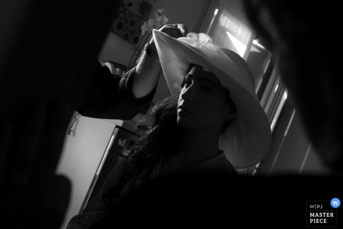 Photo by: <a href="https://www.wpja.com/contests/2018-v03-photography-competition/best-wedding-photographers/2185181">Fabrizio Demasi - Gonzaga Mantova</a> Mantova bride getting her hat ready for the wedding ceremony
