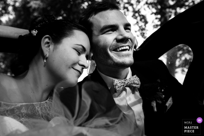 Photo by: <a href="https://www.wpja.com/contests/2018-v04-photography-competition/best-wedding-photographers/2192161">Chrystel Echavidre - Saubrigues </a> France bride puts her head on grooms shoulder while in the car after the wedding ceremony