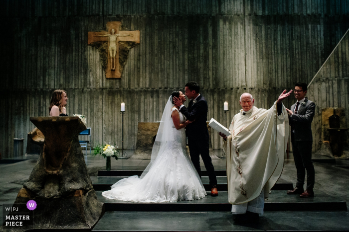 Berkeley, California bride and groom kiss at the wedding ceremony