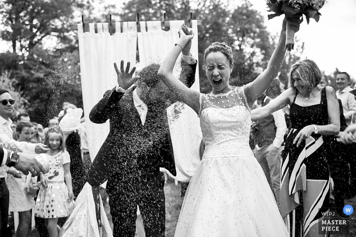Photo by: <a href="https://www.wpja.com/contests/2018-v06-photography-competition/best-wedding-photographers/2205986">Matthieu Muratet - Issoire </a> Photo of guests throwing rice at the bride and groom after the wedding ceremony in Chateau de Miremont, Auvergne, France