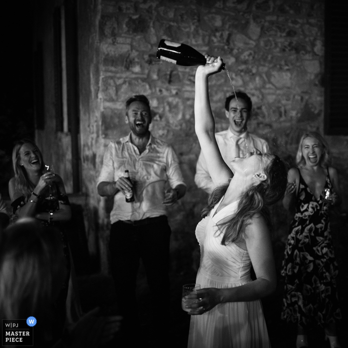 Photo by: <a href="https://www.wpja.com/contests/2018-v06-photography-competition/best-wedding-photographers/2211211">Massimiliano Beccati - Milano Milano</a> Bride enjoying her drinks at the wedding reception in Tenuta di Camposervoli, Siena, Italy