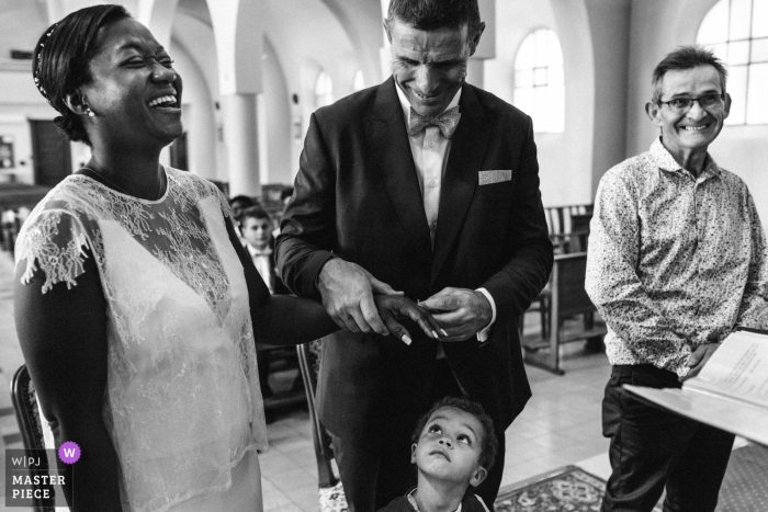 Candid photo of the ring ceremony inside a church in Montelimar