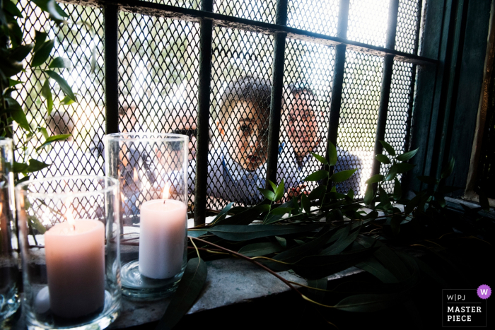 Photo by: <a href="https://www.wpja.com/contests/2018-v06-photography-competition/best-wedding-photographers/2214486">Francesco Survara - Rome Roma</a> Photo of guests looking through a window at the wedding at Casale del Polline, Rome