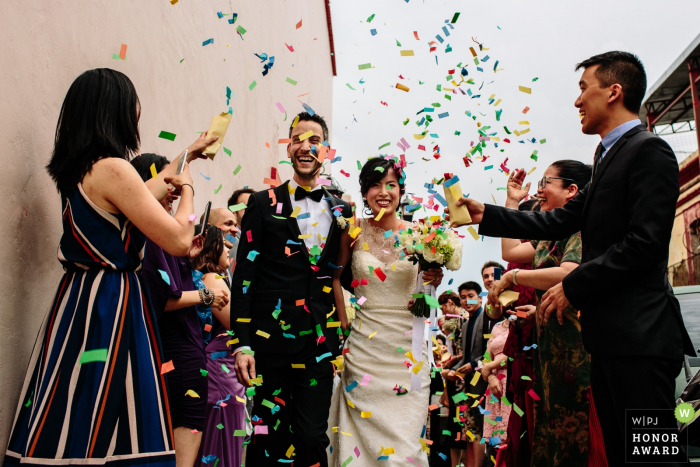 the bride and groom under a rainbow colored shower of confetti Oaxaca City, Oaxaca, Mexico bride and groom under a rainbow colored shower of confetti