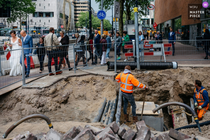 Photo by: <a href="https://www.wpja.com/contests/2018-v08/best-wedding-photographers/2235361">Leonard Walpot - Utrecht Utrecht</a> Bride and groom walk passed construction after the wedding in Rotterdam