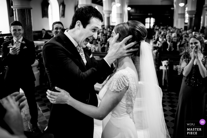 Bride and groom smile at each other during the wedding ceremony in Cork, Ireland Bride and groom smile at each other during the wedding ceremony in Cork, Ireland