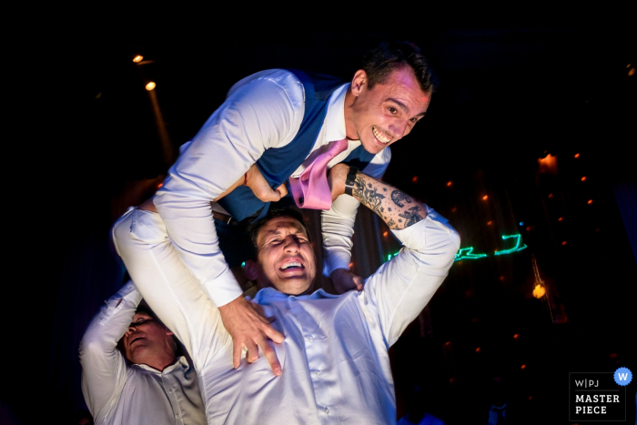 Groom and best man having fun at the wedding reception in Rosario, Argentina