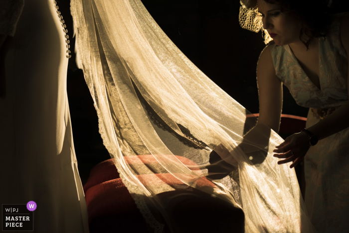 Bride getting help with her dress Bride getting help with her dress before the wedding ceremony in Iglesia de Santa María de Sagunto