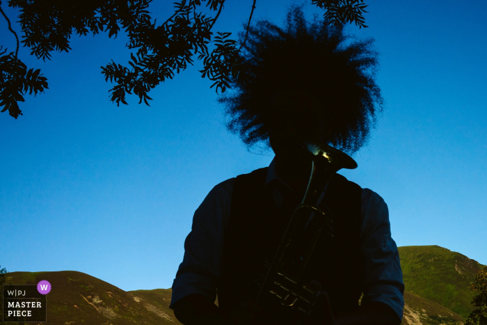 Outdoor photo of musician playing at the wedding reception in Lake district, UK