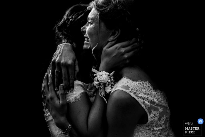 the Bride hugs maid of honor at the wedding Bride hugs maid of honor at the wedding in Clos des Tourelles