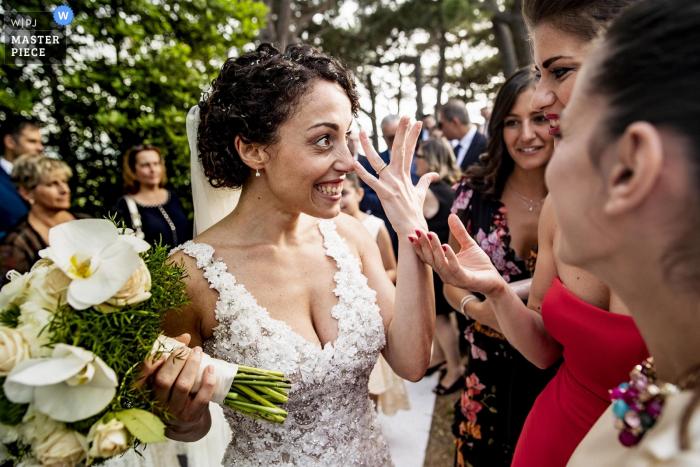 the bride shows off the wedding ring to guests after the ceremony Calabria bride shows off the wedding ring to guests after the ceremony