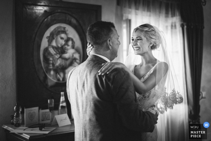 Bride hugs her father before the wedding ceremony in Abbazia San Faustino